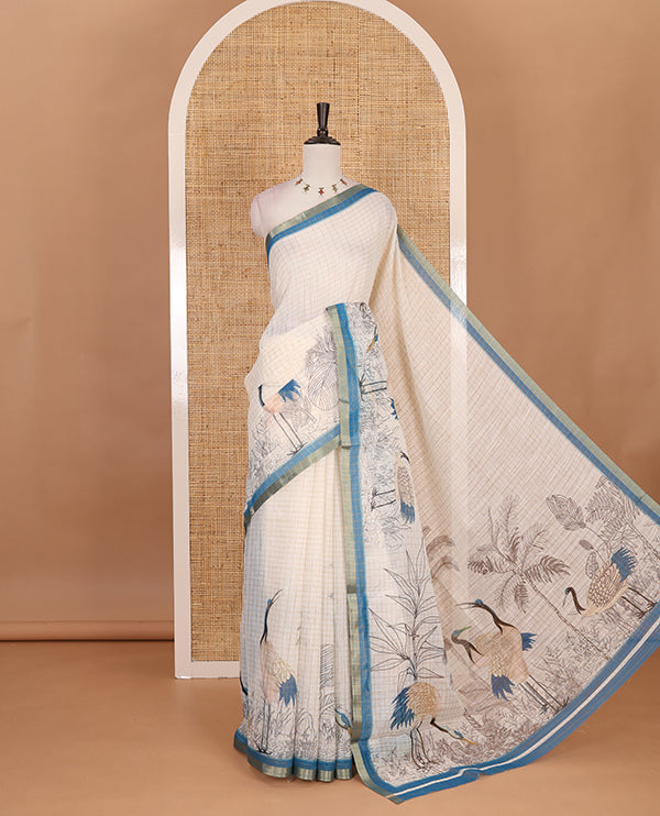 White with blue zari checks linen saree with contrast border and unique designs of pallu along with contrast plain blouse