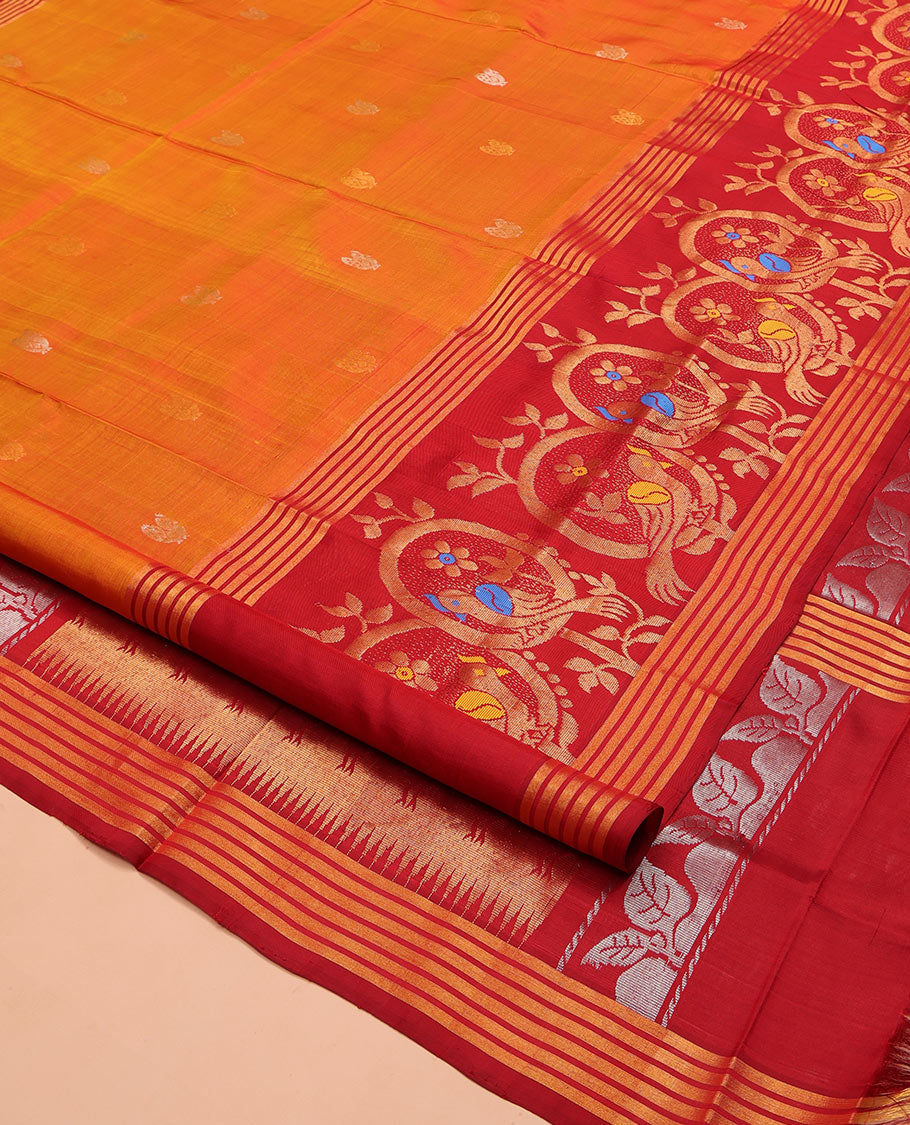 Orange Uppada Silk Saree, Decked Up with Zari Buttas on Its Body, Complemented by a Contrast Border Featuring Floral and Meenakari Bird Designs, Pallu Steeped with Flower Designs, and Paired with a Contrast Blouse