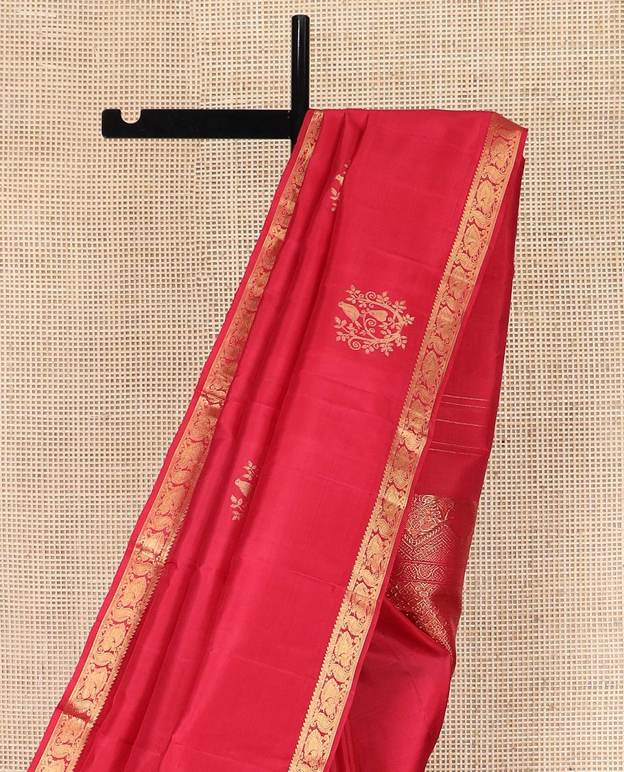 Red Kanchipuram Silk Saree Accentuated with Zari Buttas, Highlighted with Zari Border of Ara Bogudi, Muthu, and Mayil Designs, Grandly Woven Pallu of Jaal Designs, and Paired with a Matching Blouse