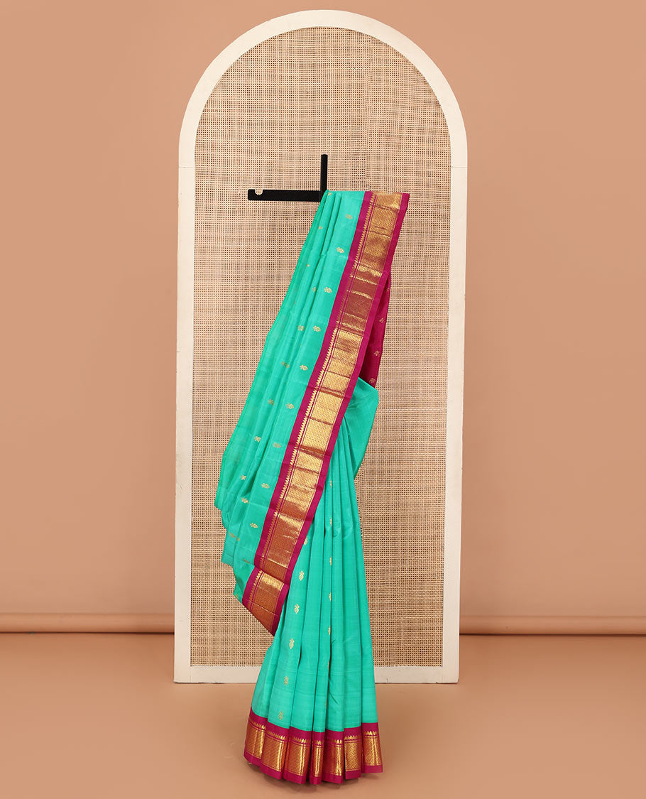 Green zari buttas Kanchipuram silk saree, contrast korvai border of thilakam mokku, and puli nagam, and zari design pallu