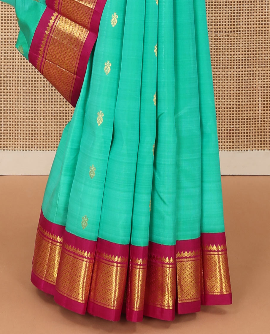 Green zari buttas Kanchipuram silk saree, contrast korvai border of thilakam mokku, and puli nagam, and zari design pallu