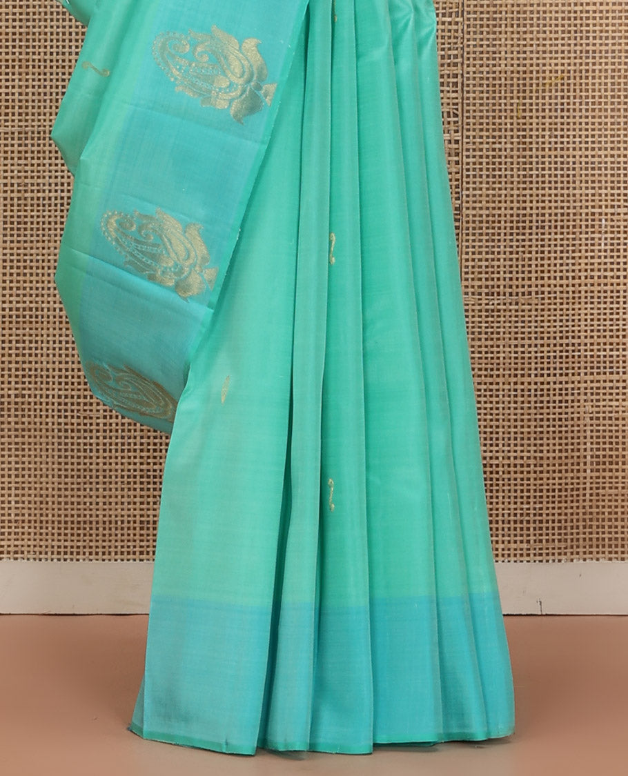 Turquoise Kanchipuram Silk Saree Woven with Zari Buttas, Subtly Sprakled Contrasting Border of Manga Designs, Zari Motifs Woven Pallu, and Paired with a Contrast Blouse