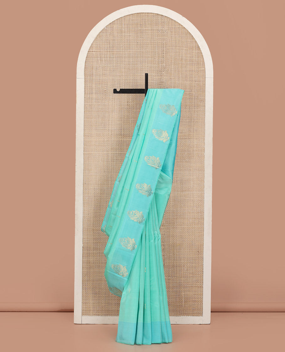 Turquoise Kanchipuram Silk Saree Woven with Zari Buttas, Subtly Sprakled Contrasting Border of Manga Designs, Zari Motifs Woven Pallu, and Paired with a Contrast Blouse