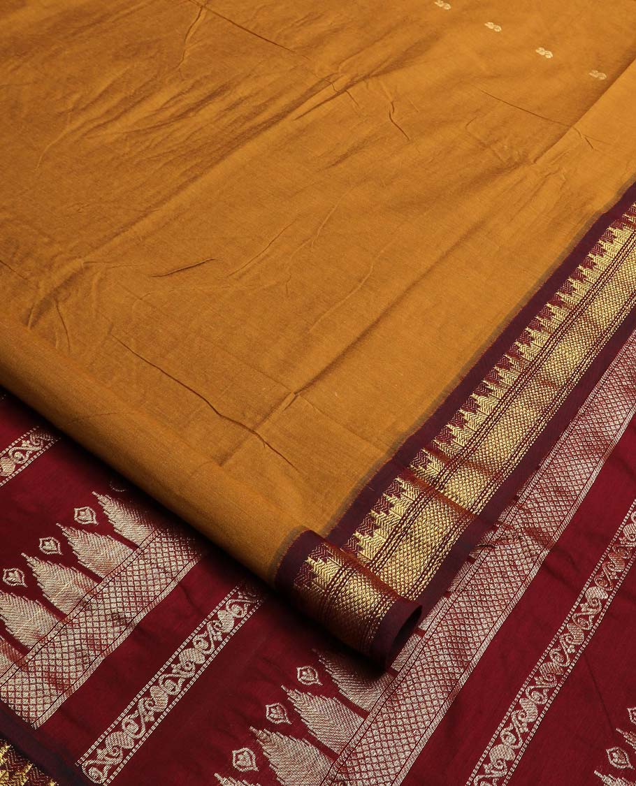 Mustard buttas nine-yard cotton saree, contrast traditional zari border, and pallu steeped with traditional motifs