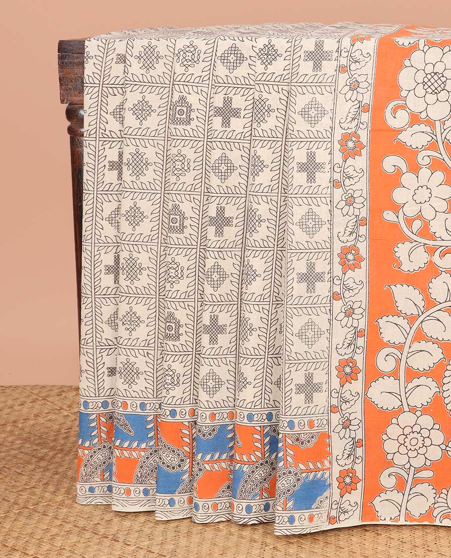 Cream Machine-Printed Kalamkari Cotton Saree Features Kolam Motifs Enclosed Checks on Its Body, Complemented by Contrast Printed Border, Pallu Depicts Floral and Peacock Print, and Paired with a Floral Printed Blouse