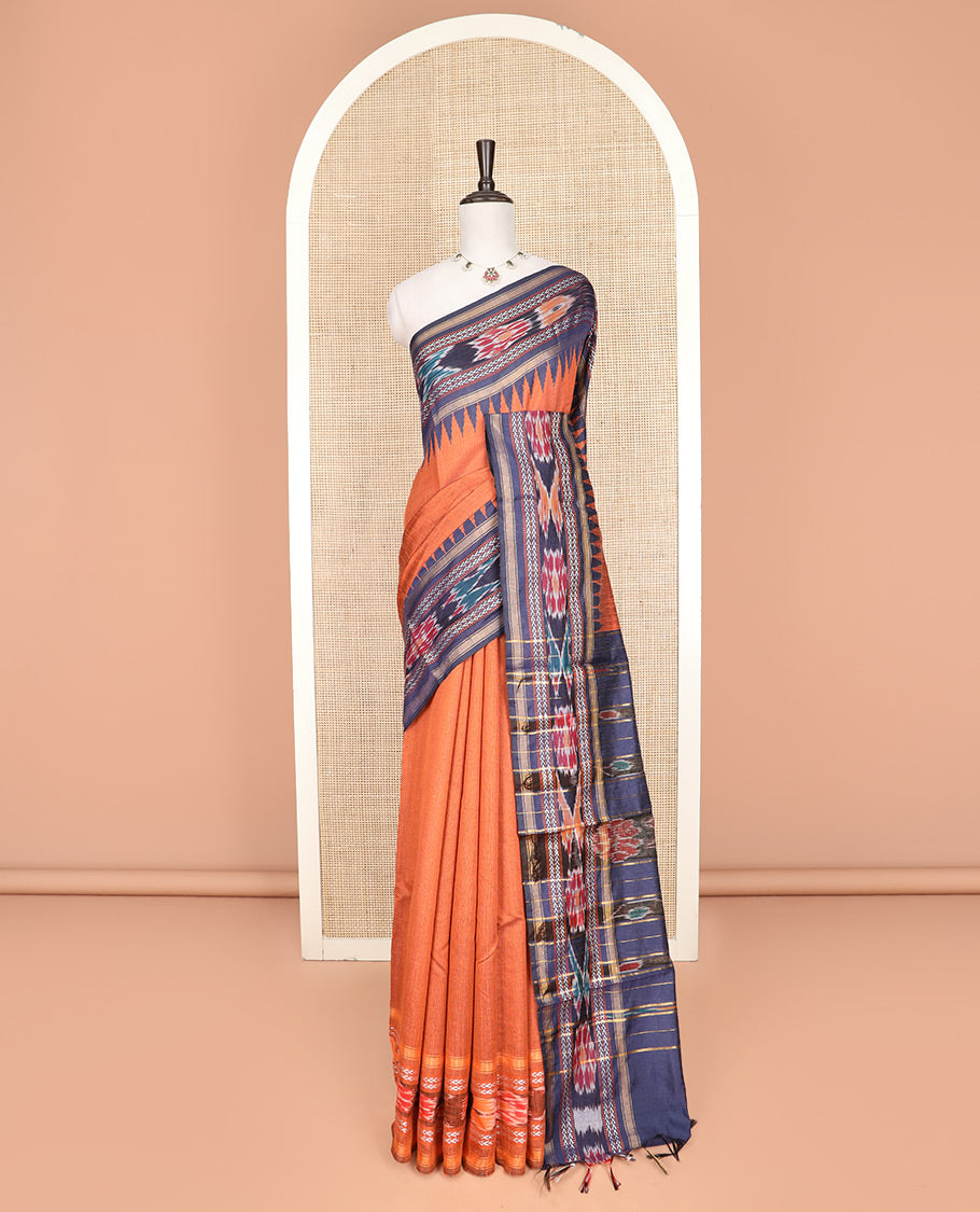 Orange Plain Dupion Silk Saree, Adorned with a Contrast Temple Border of Geometric Patterns and Ikkat Weave, Pallu Depicting Floral Ikkat Designs, and Paired with a Contrast Blouse