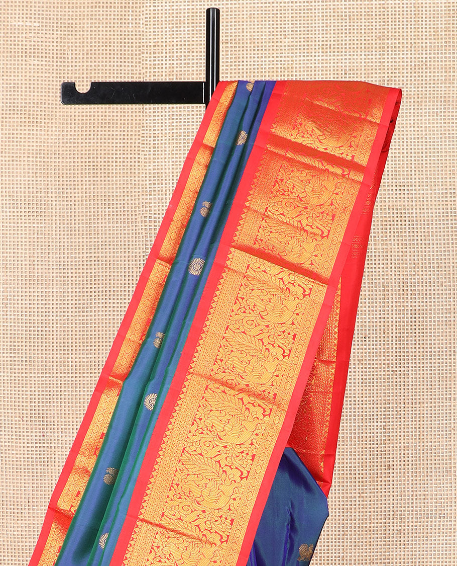 Blue mayil chakram buttas Kanchipuram silk saree, contrast korvai border of thilakam mokku, cross kamalam, and mayil designs, and intricate pallu