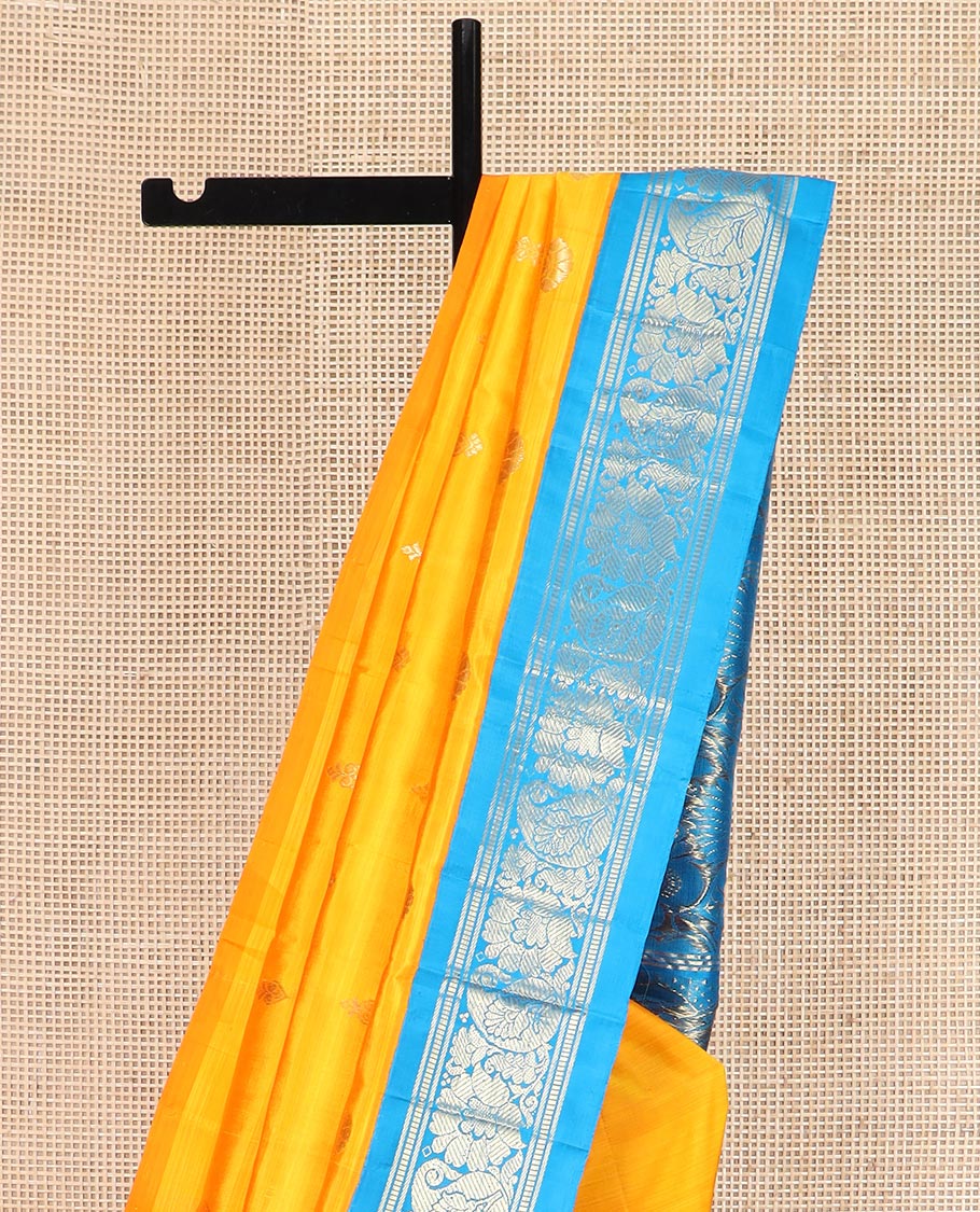 Yellow Kanchipuram Silk Saree Sparsely Sparkled with Zari Buttas All Over Its Body, Complemented by a Contrast One-Sided Korvai Border of Banaras, Muthu, Manga, and Floral Designs, Pallu of Floral Designs, and Comes Without a Blouse