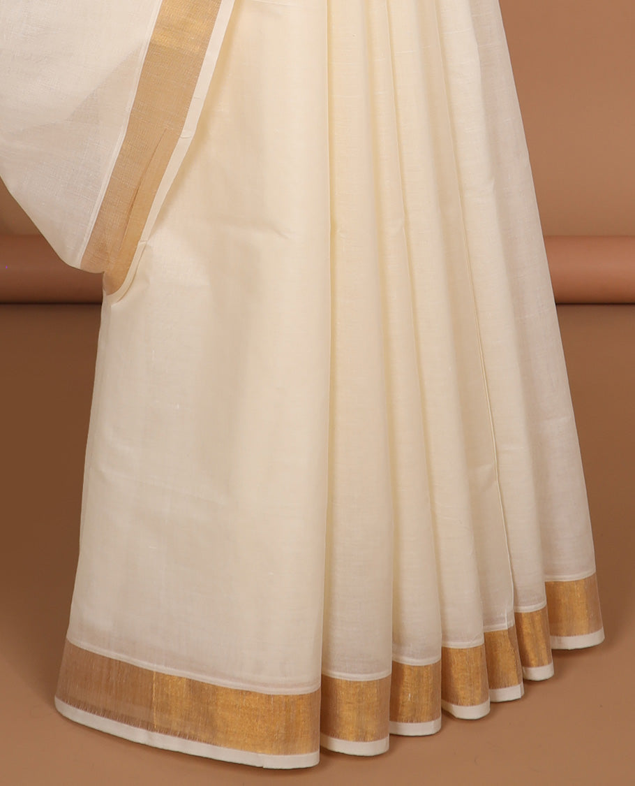 Cream kerala saree with zari buttas, plain border & pallu of peacock designs