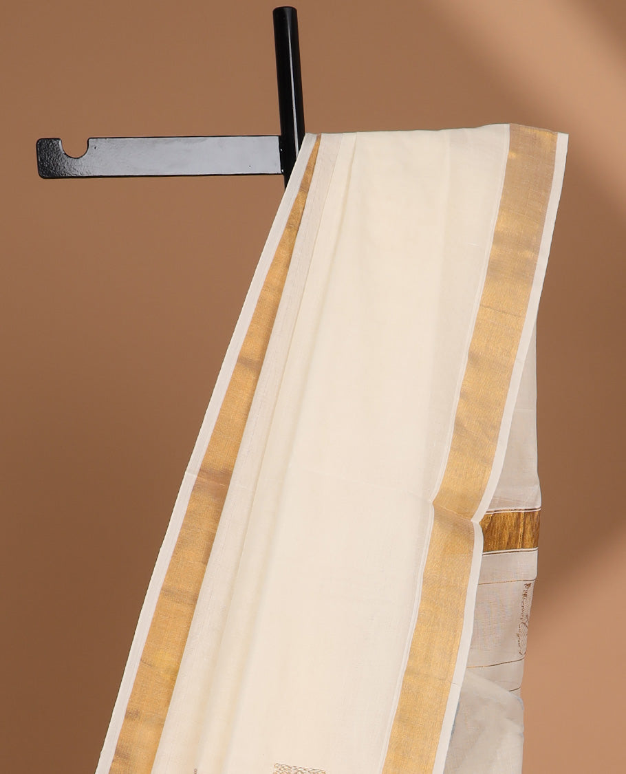 Cream kerala saree with zari buttas, plain border & pallu of peacock designs