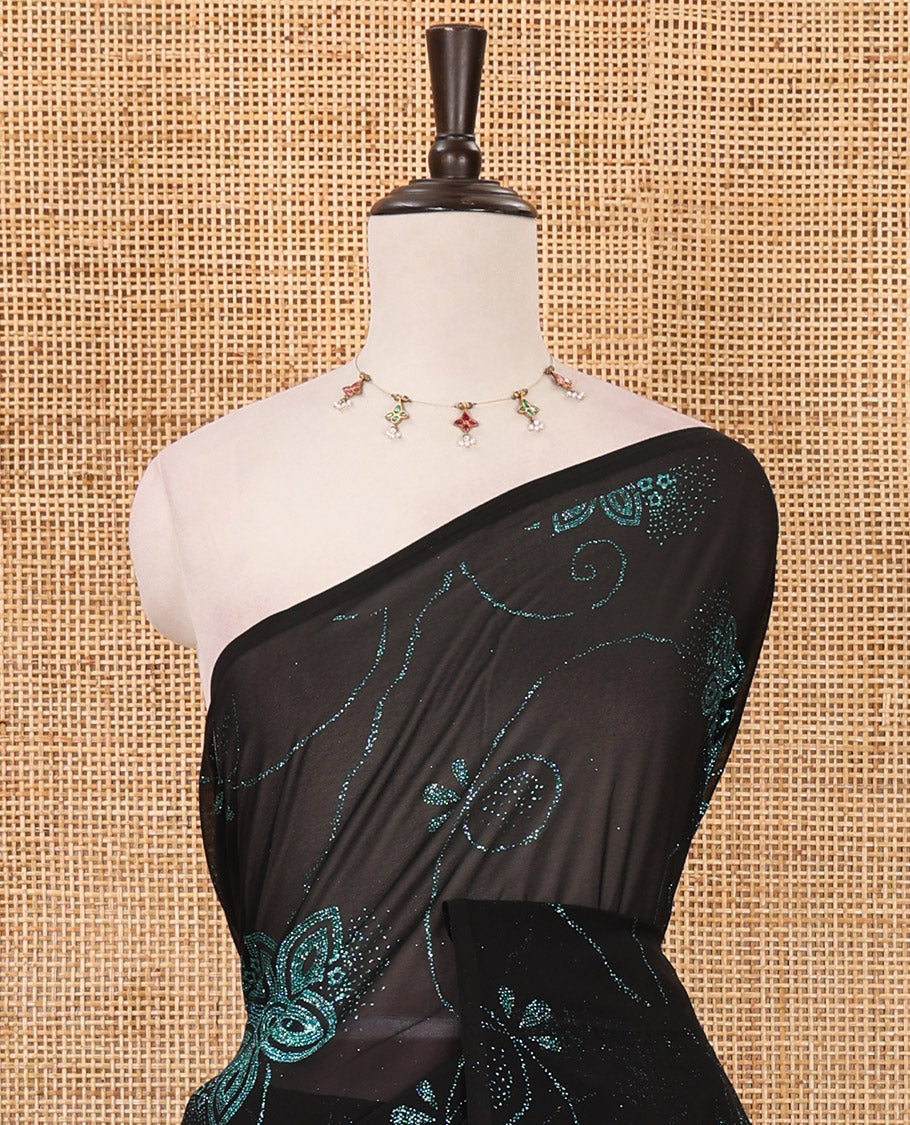 Borderless black 60 gm georgette saree features floral vine designs blue glitter embroidery work, contrast plain blouse