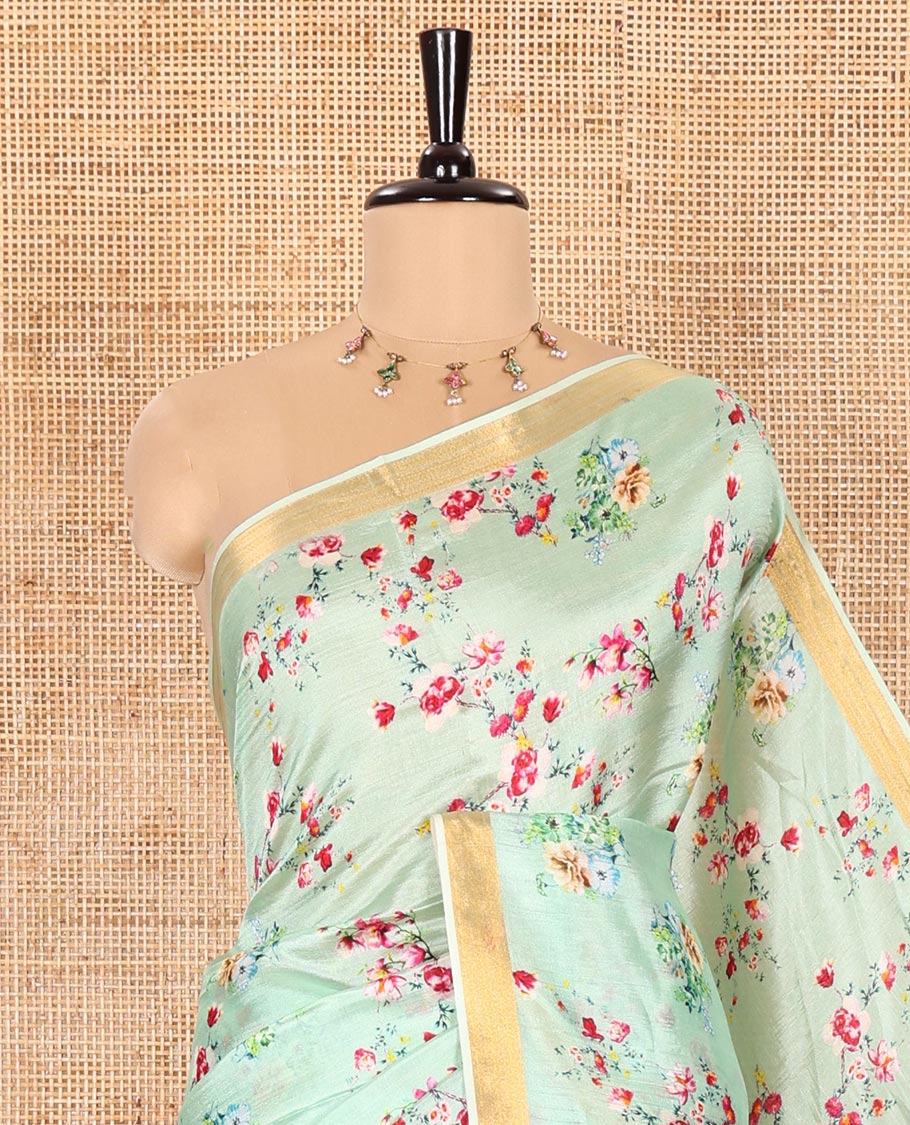 Mint Green Banana Pith Saree Prettified with Multi-Color Floral Vine Print, Subtle Small Bavanji Border, Gleaming Zari Striped Pallu, and Complemented with a Contrast Floral-Printed Blouse