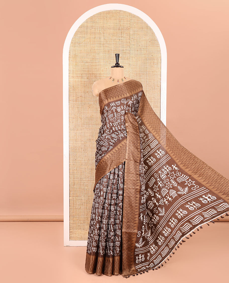 Brown Art Khadi Cotton Saree Beautified with Warli-Village Theme Print, Complemented with a Contrasting Chevron-Printed Border, Vibrantly Warli-Printed Pallu, and a Plain Blouse