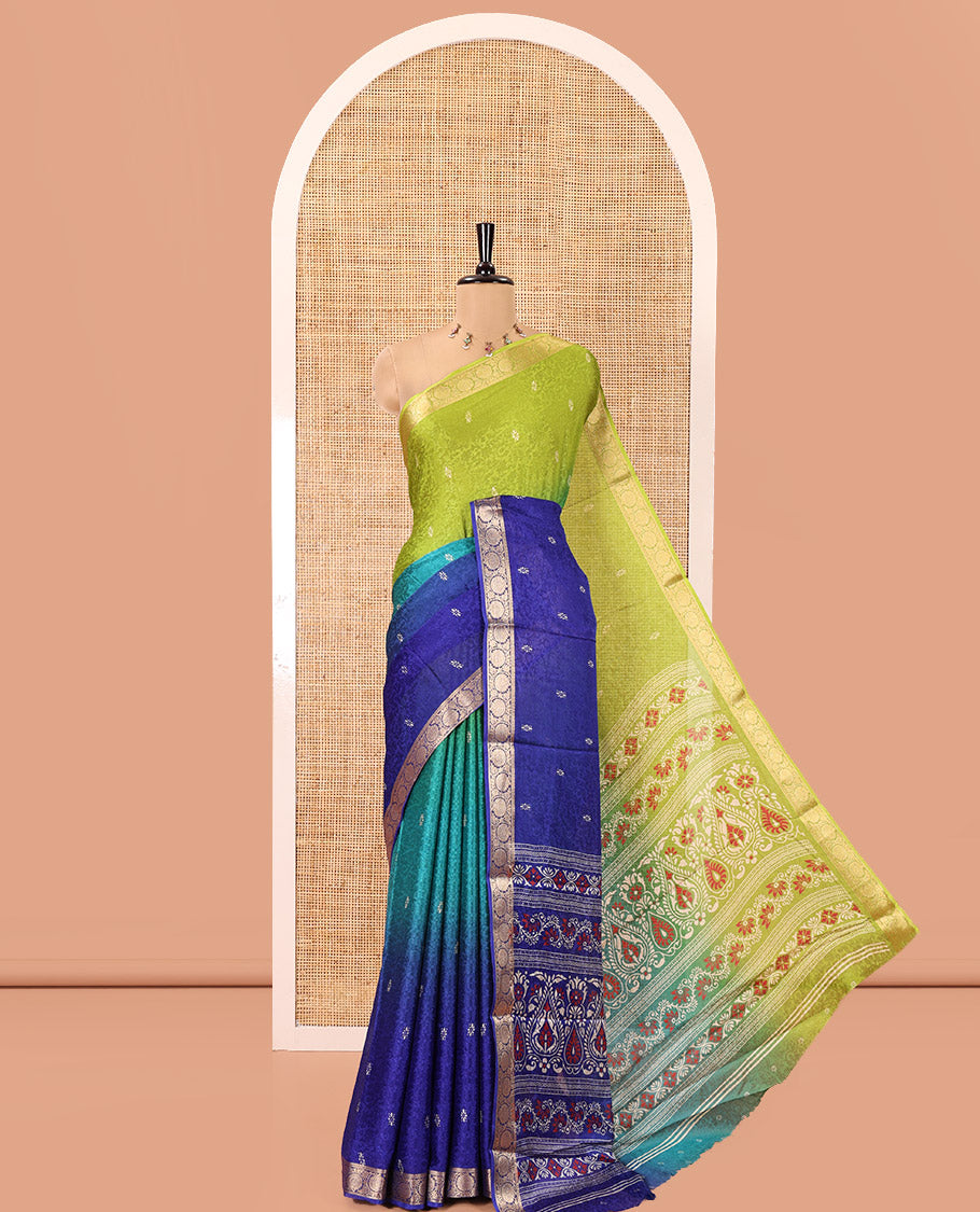 Green and Royal Blue Candy Chiffon Saree, Featuring Floral Vine Embossed, Buttas, and Ombre-Style Dyed on Its Body, Highlighted by Floral Creeper Zari Border, Intricately Designed Pallu, and Paired with a Contrast Blouse