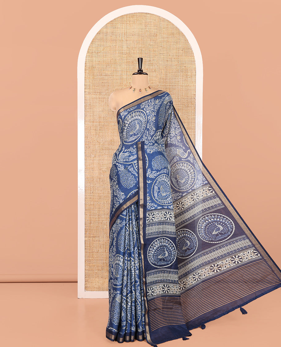 Indigo Blue Muslin Cotton Saree, Beautified with Round Peacock Motifs and Floral Print on Its Body, a Subtle Zari Border, Striped Pallu, and Paired with a Matching Blouse