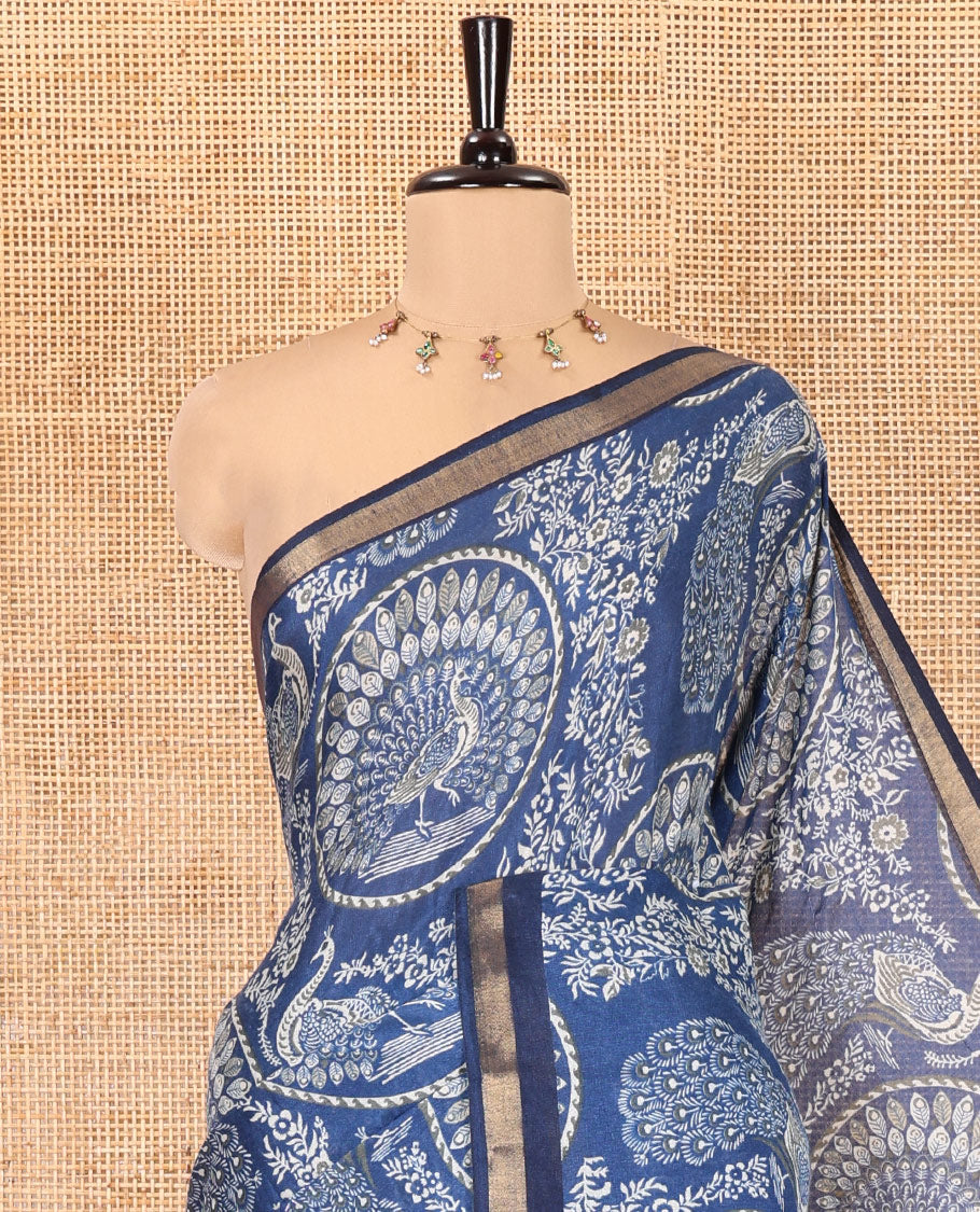 Indigo Blue Muslin Cotton Saree, Beautified with Round Peacock Motifs and Floral Print on Its Body, a Subtle Zari Border, Striped Pallu, and Paired with a Matching Blouse