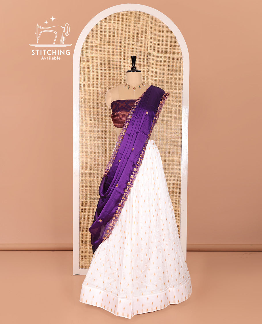 Cream and Purple Half-Saree Featuring Gold Zari Buttas Steeped Nylon Viscose Skirt, Complemented by a Contrast Jacquard Zari Design Blouse, and Comes with a Syska Georgette Embroidered Scallop-Bordered Dhavani