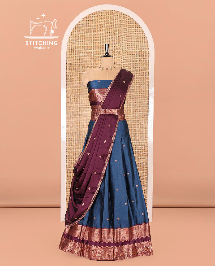 Blue-Purple Semi-Banarasi Half-Saree Enriched with Zari Buttas on Its Skirt, Complemented by a Contrast Traditional Zari Temple Rettai Pettu Border, Paired with a Matching Blouse, and a Satin Georgette Embroidered Scallop Dhavani