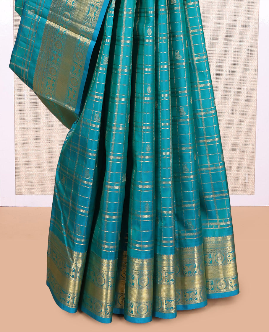 Neelambhari - Peacock Blue Vasundhara Silk Saree Gleamed Up with Zari Buttas Enclosed in Zari Checks, Featuring a Zari Border of Kuthirai and Chakra Designs, Rich Zari Pallu, with a Matching Blouse