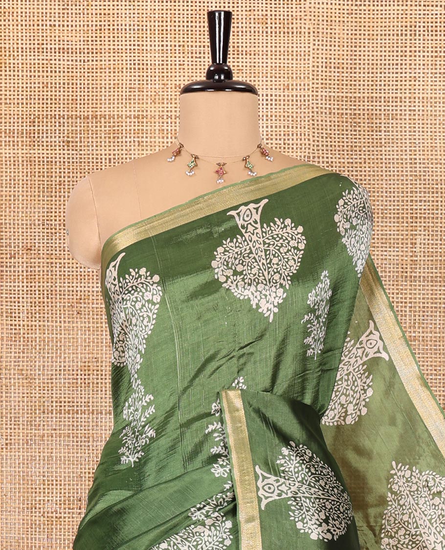 Forest green tree motifs discharge printed banana pith saree, zari piping border, floral printed pallu, and a tree discharge printed blouse