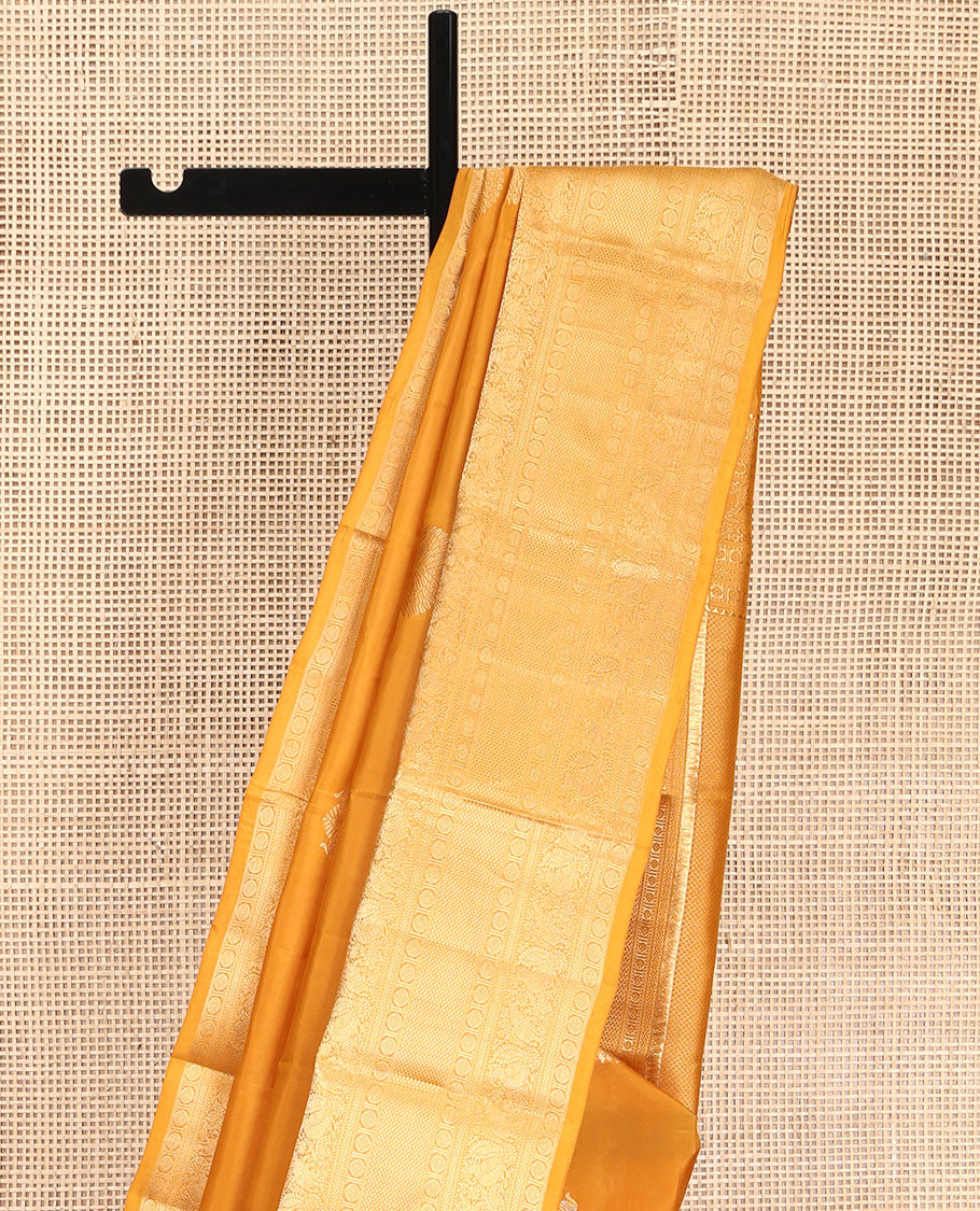 Yellow Vasundhara Lite Silk Mix Saree, Decorated with Zari Buttas, Highlighted by a Zari Border of Thilakam Mokku, Muthu, Kamalam, Mayil, Yaanai, Rettai Neli, and Mayil Kann Designs, Pallu of Mayil Kann Designs, and Paired with a Matching Blouse