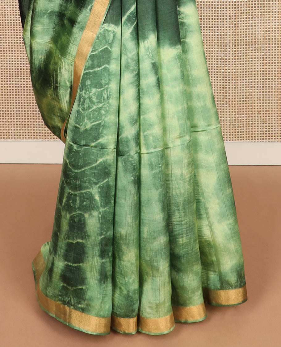 Green shibori printed banana pith saree, zari piping border, and zari striped pallu