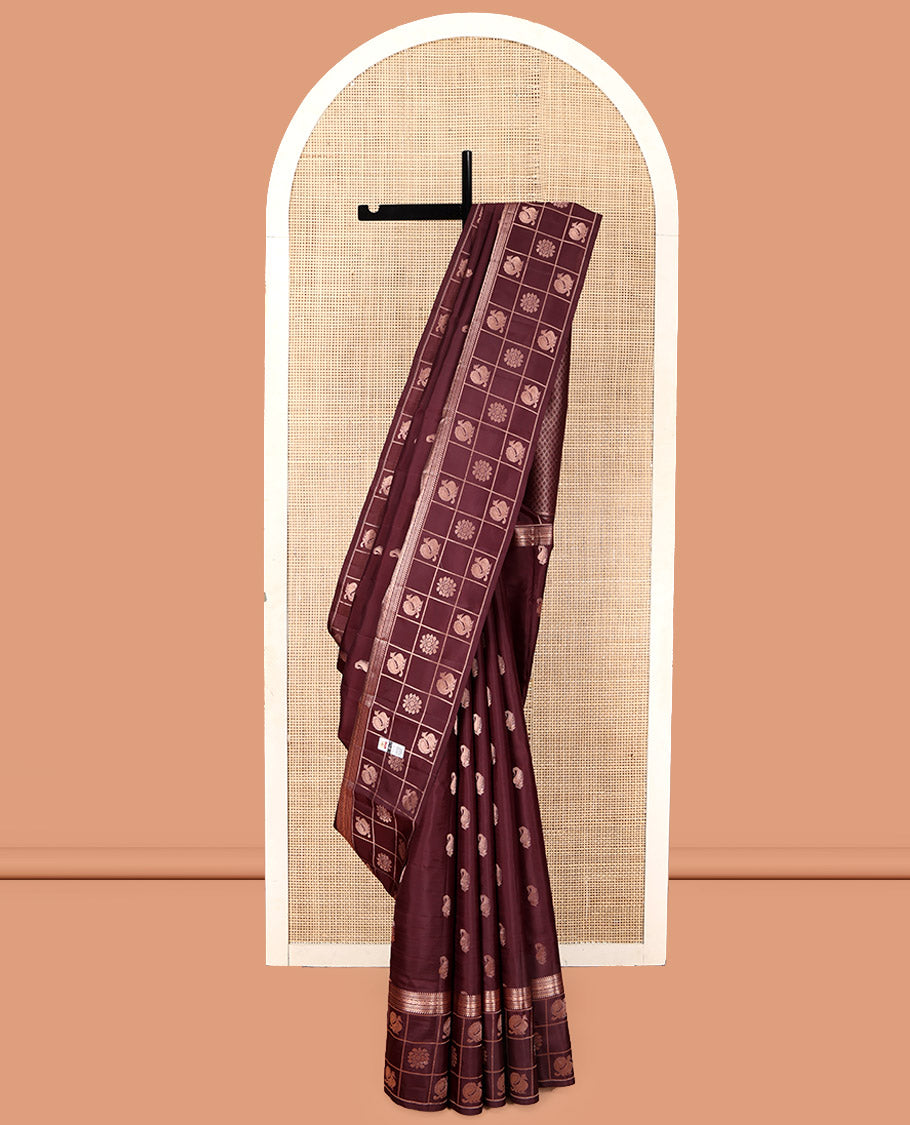 Brown Vasundhara Silk Saree, Artfully Detailed with Zari Buttas, Highlighted by a Zari Border of Rekku, Muthu, Jada Nagam, and Butta Enclosed Checks, Jaal Pallu, and a Matching Blouse
