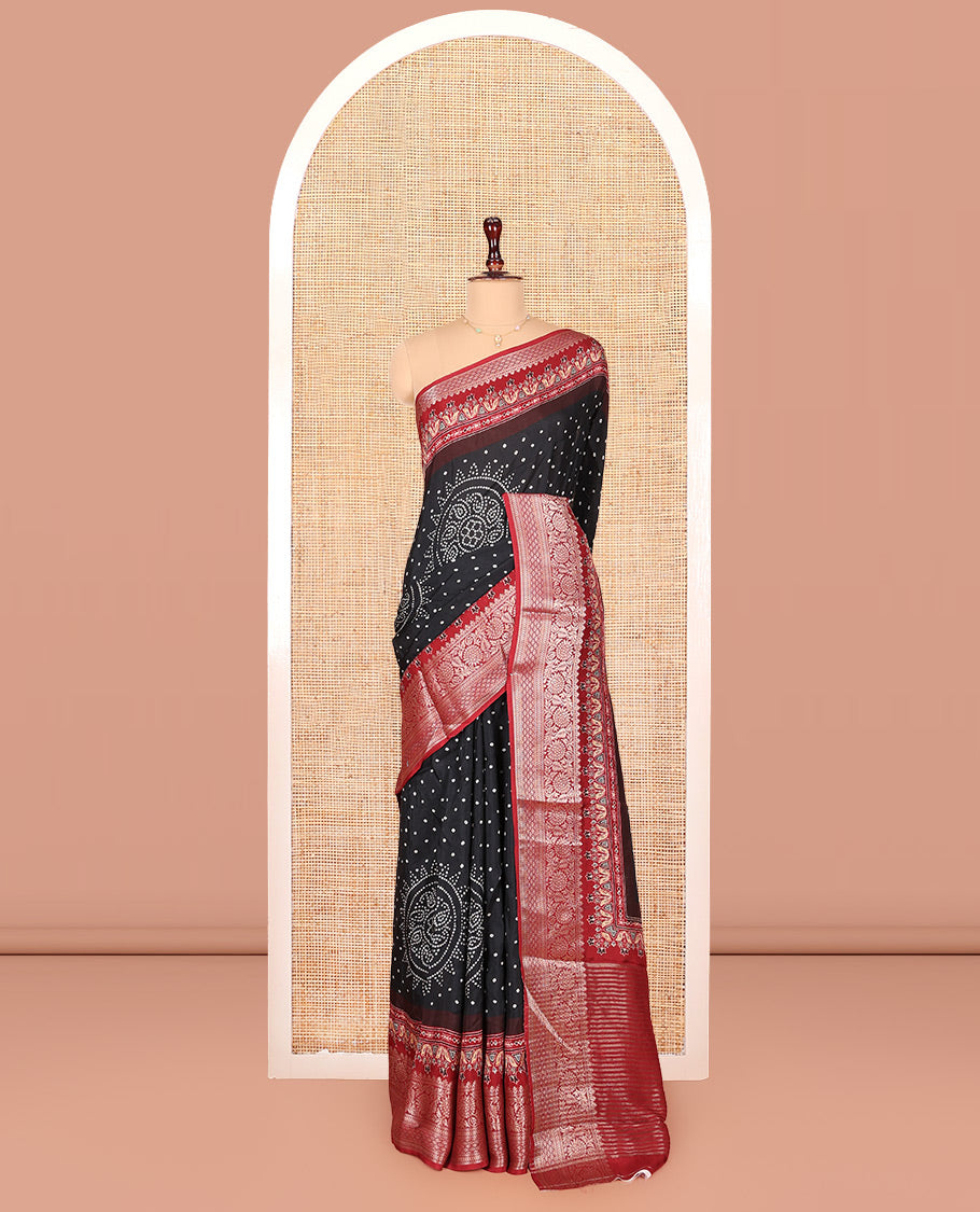 Black Dola Silk Saree, Detailed with Bandhani Dots on Its Body, Complemented by Contrast Border, Zari Striped Pallu, and Paired with a Contrast Blouse