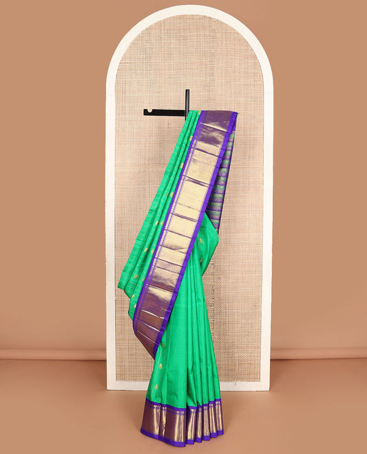 Green zari buttas Kanchipuram silksaree, contrast one-sided korvai border of manga mokku & vanki design & pallu of kodi visiry designs