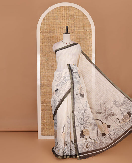 White with green zari checks linen saree with contrast border and unique designs of pallu along with contrast plain blouse