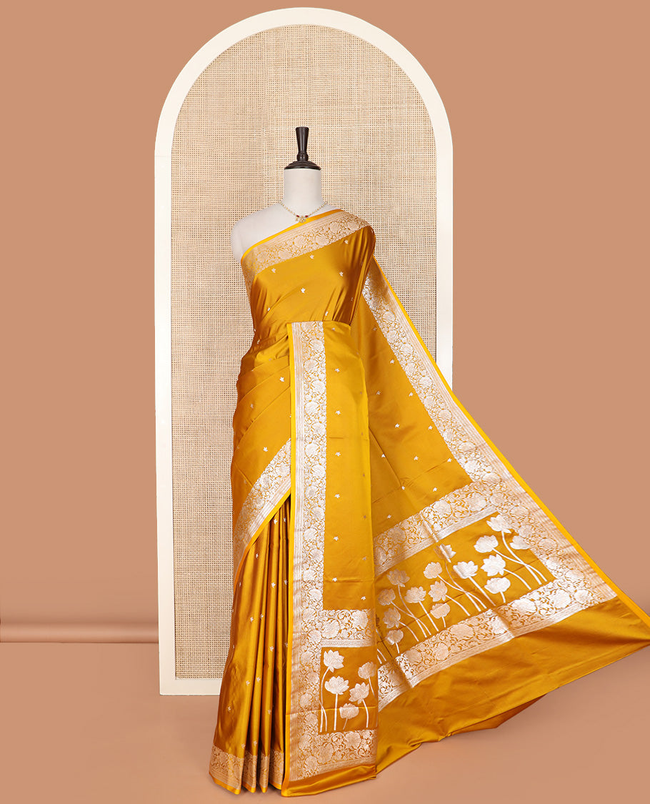 Yellow Semi-Banaras Satin Saree Subtly Sparkled with Zari Buttas, Self-Border Gleamed Up with Floral Creeper Designs, Pallu Creatively Woven of Lotus Motifs, and Paired with a Matching Blouse