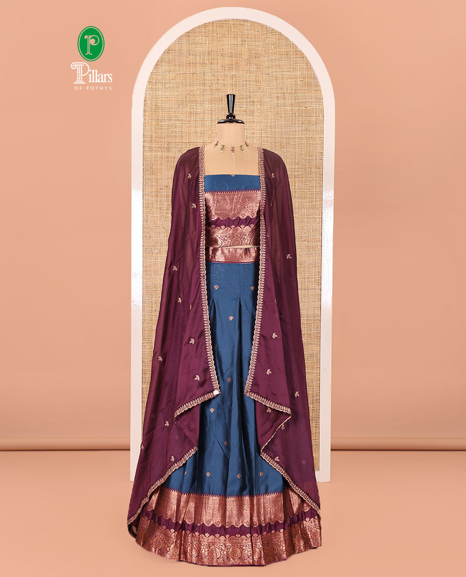 Blue-Purple Semi-Banarasi Half-Saree Enriched with Zari Buttas on Its Skirt, Complemented by a Contrast Traditional Zari Temple Rettai Pettu Border, Paired with a Matching Blouse, and a Satin Georgette Embroidered Scallop Dhavani