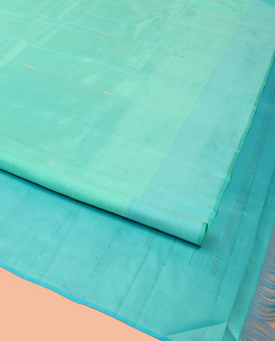 Turquoise Kanchipuram Silk Saree Woven with Zari Buttas, Subtly Sprakled Contrasting Border of Manga Designs, Zari Motifs Woven Pallu, and Paired with a Contrast Blouse