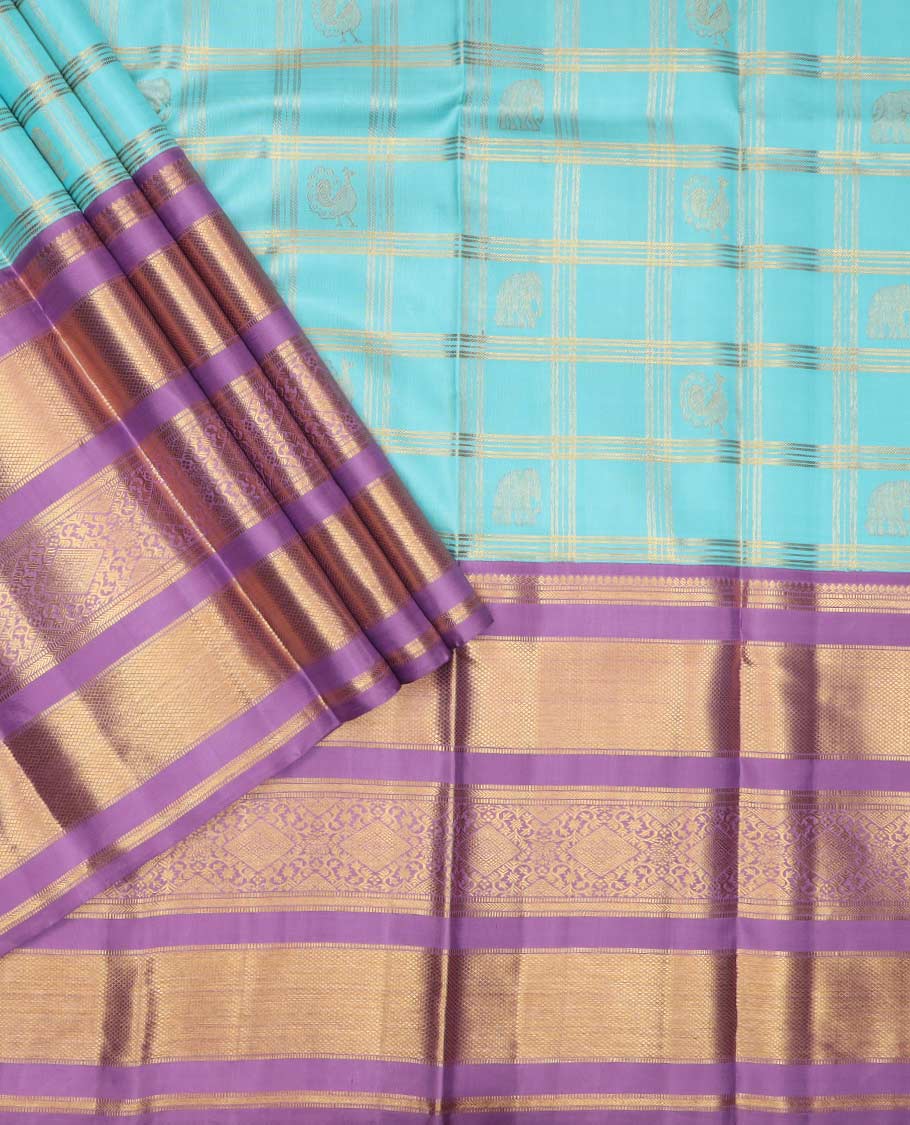 Blue puresilk halfsaree, yaanai and mayil butta enclosed checked skirt, contrast blouse and border of traditional designs in zari, and zari design dhavani