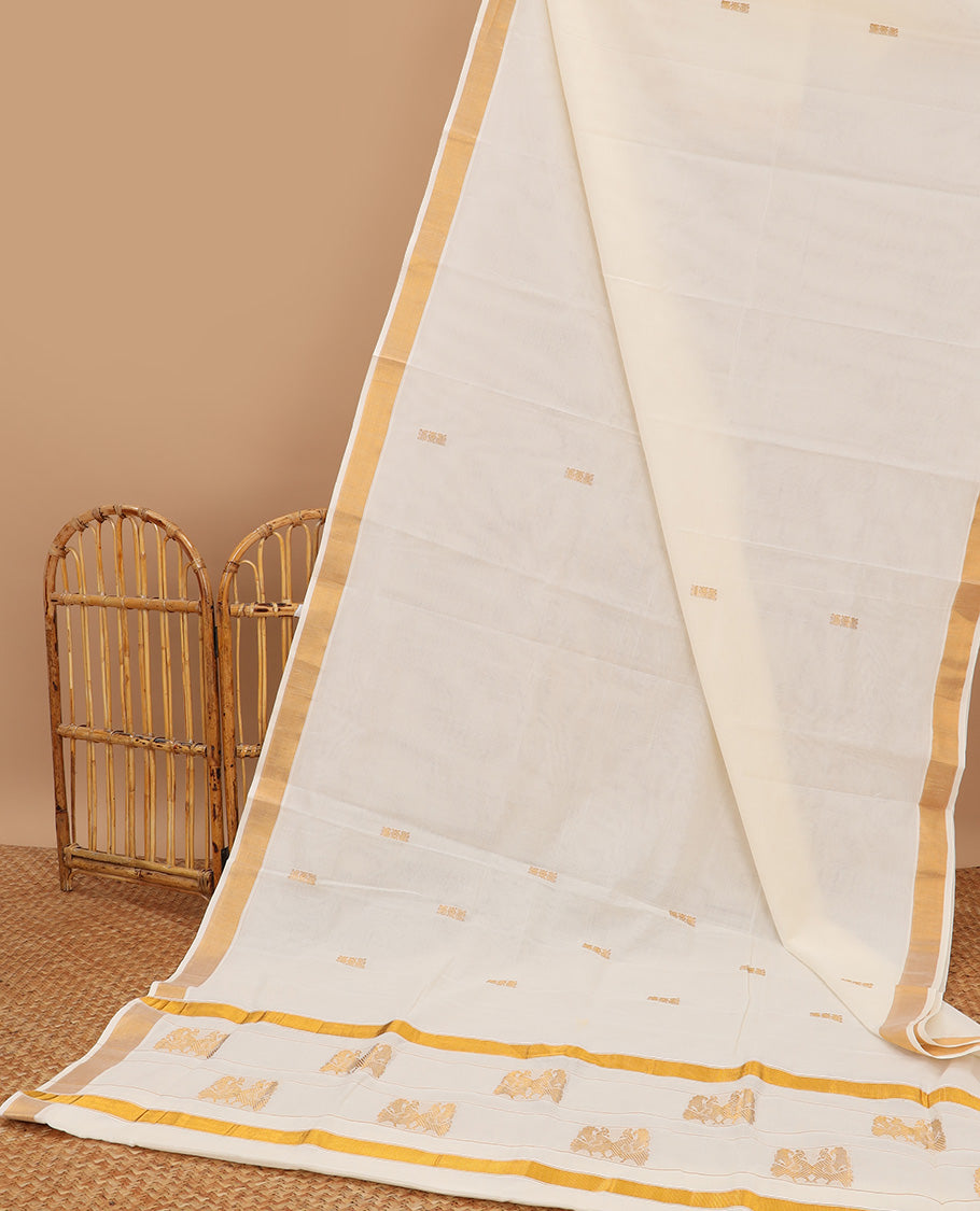 Cream kerala saree with zari buttas, plain border & pallu of peacock designs