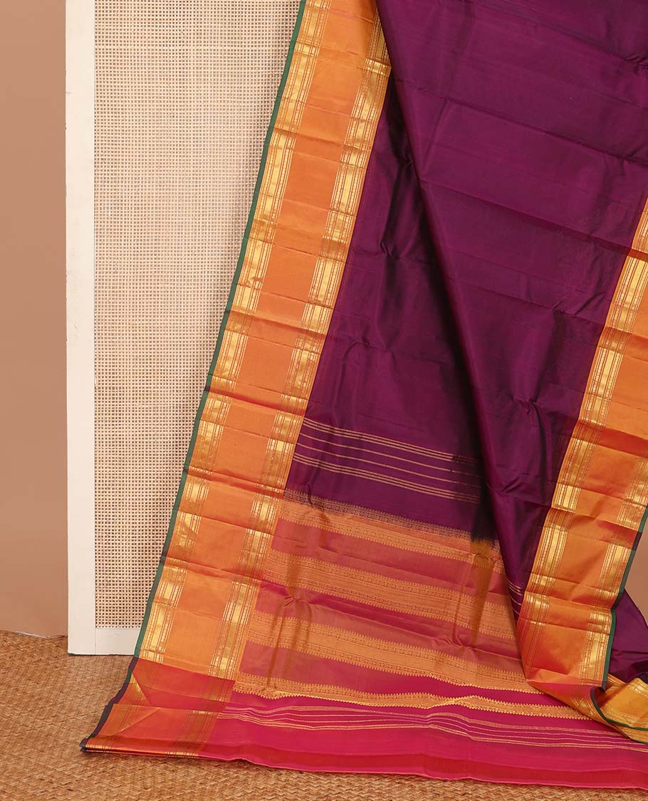 Purple plain Kanchipuram silk saree, contrast rettai pettu border of rekku, banaras, poun, and vanki designs, and zari design pallu