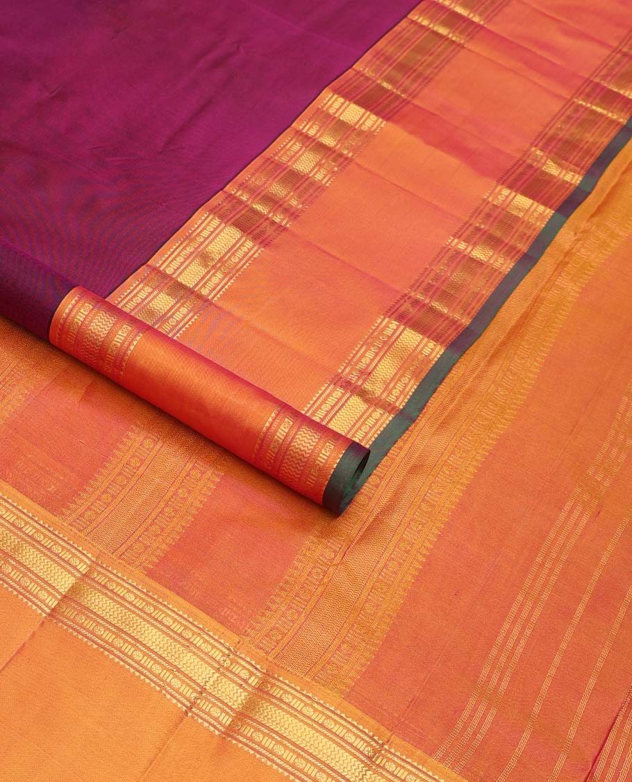 Purple plain Kanchipuram silk saree, contrast rettai pettu border of rekku, banaras, poun, and vanki designs, and zari design pallu