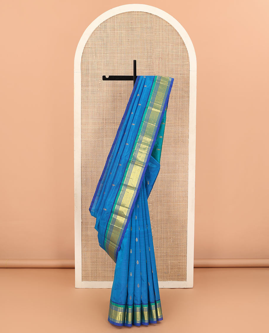 Blue zari buttas Kanchipuram silk saree, contrast one-sided border of paneer sombu, banaras, and jaal designs, and zari design pallu