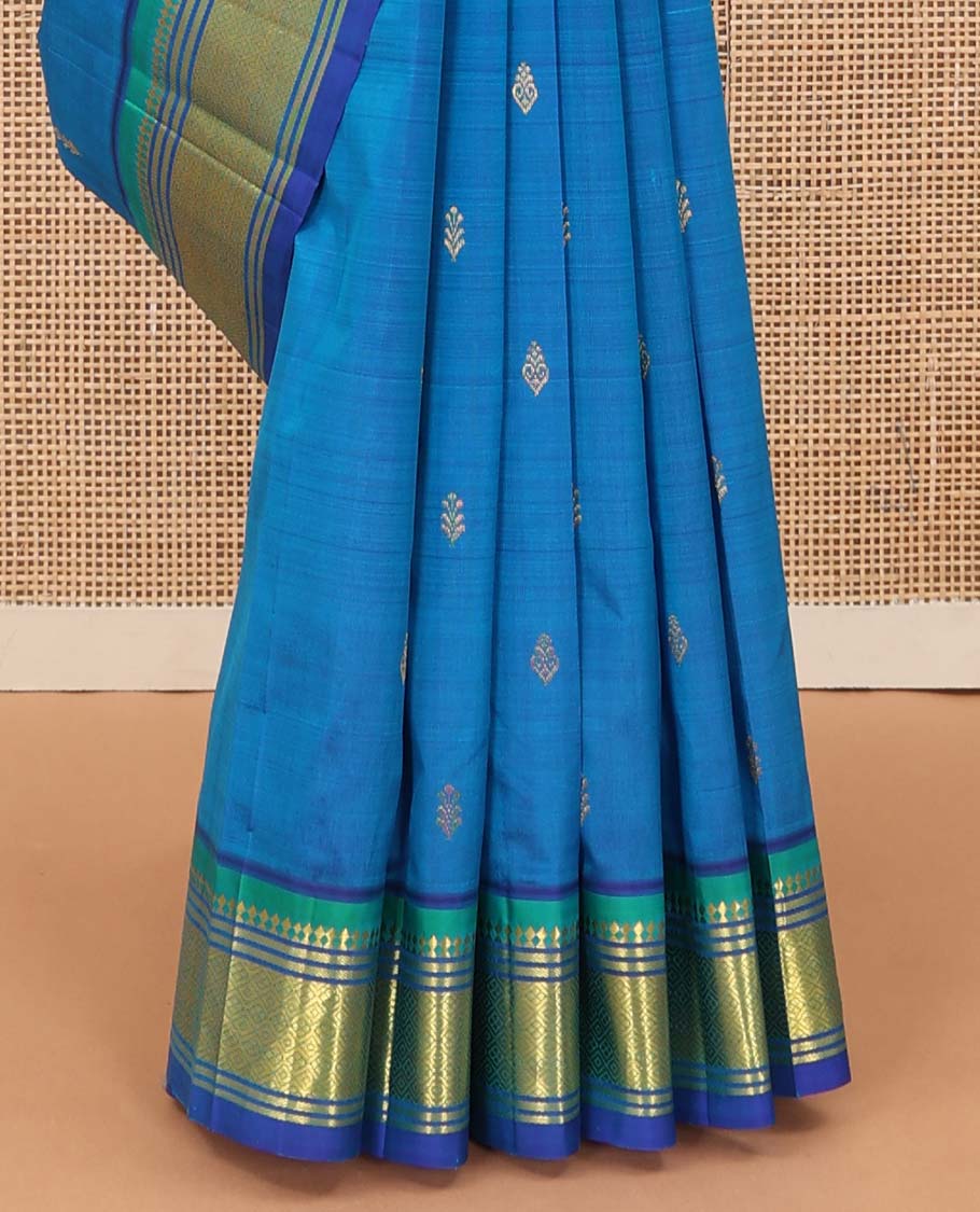 Blue zari buttas Kanchipuram silk saree, contrast one-sided border of paneer sombu, banaras, and jaal designs, and zari design pallu