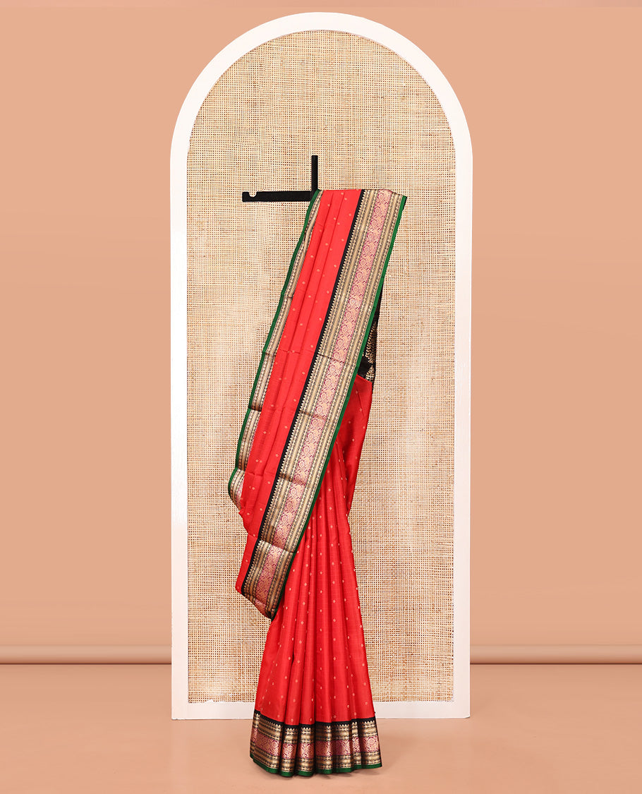 Red Vasundhara Silk Saree, Sparsely Woven with Zari Buttas All Over Its Body, Complemented by a Contrast Border of Rekku, Muthu, Poun, Kathir, and Mayil Designs, Beautifully Bedecked Pallu, and Paired with a Contrast Blouse