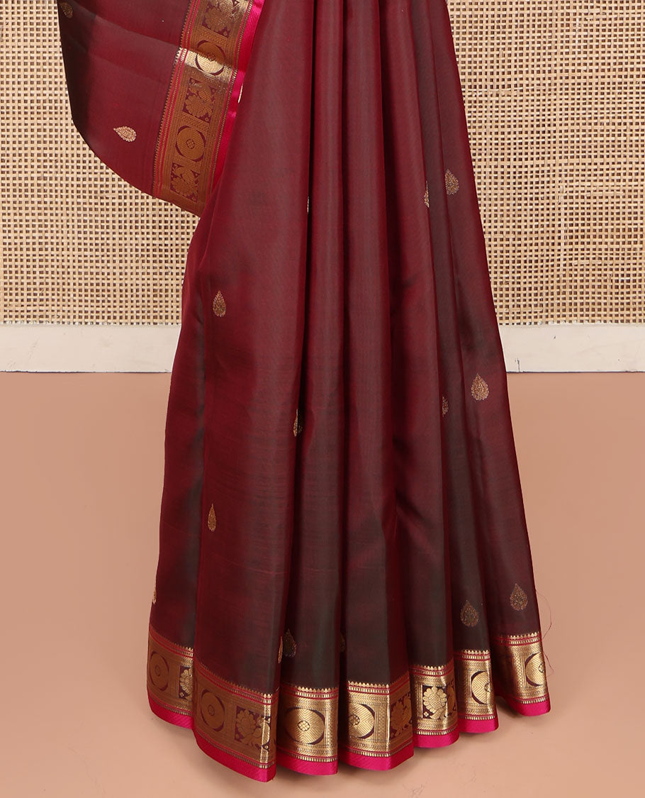 Red Wine Kanchipuram Silk Saree, Adorned with Thilakam Buttas All Over Its Body, Complemented by a Contrast Border of Rekku, Muthu, Banaras, Mayil, and Chakram Designs, Grand Jaal Pallu, and Paired with a Contrast Blouse