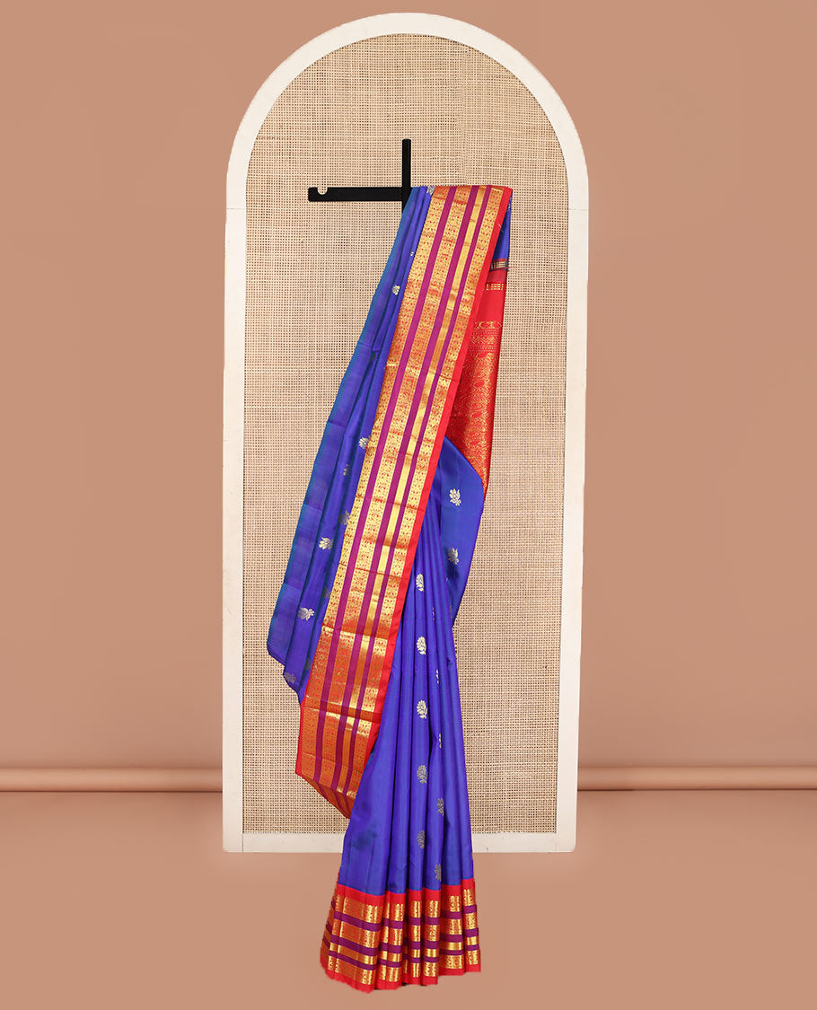 Blue Kanchipuram Silk Saree, Meticulously Crafted with Zari Buttas on Its Body, Complemented by Contrast One-Sided Border of Thilakam Mokku, Neli, Rudraksham, and Mayil Designs, Grandly Woven Pallu of Floral Designs, and Comes Without a Blouse