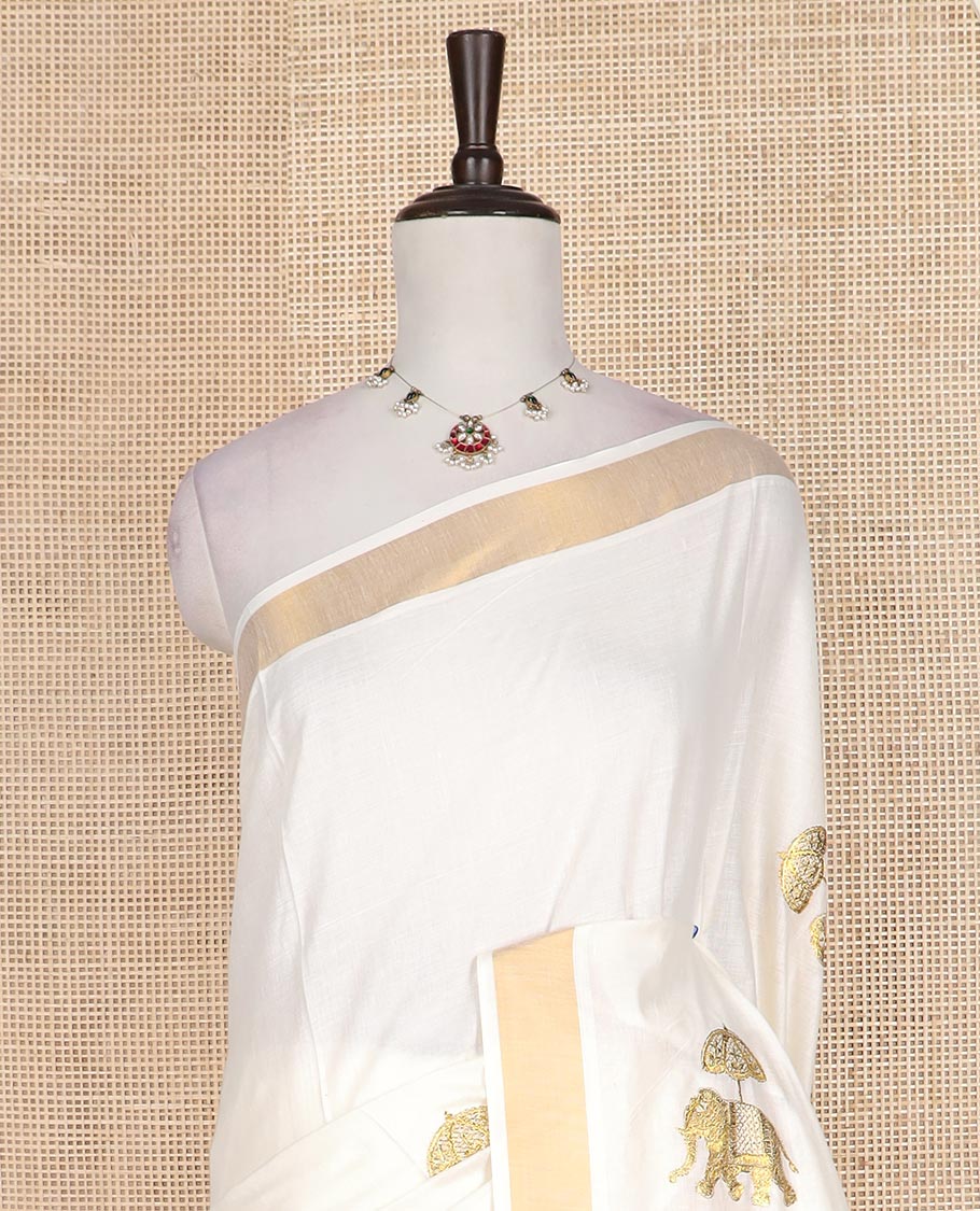 Cream elephant motifs embroidered Kerala cotton saree, zari border, and elephant motifs embroidered pallu