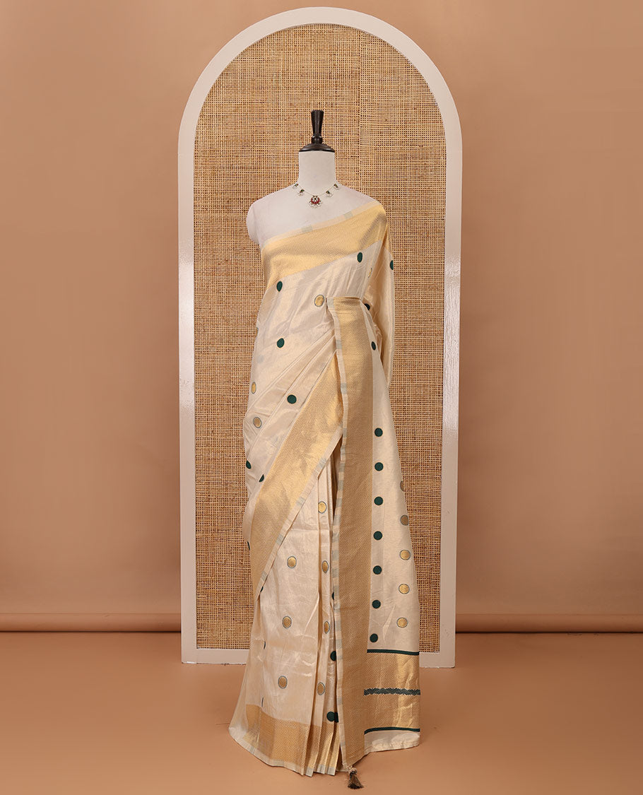 Cream small green polka dots banarasi tissue saree, zari border, pallu of green polka dots & running plain blouse
