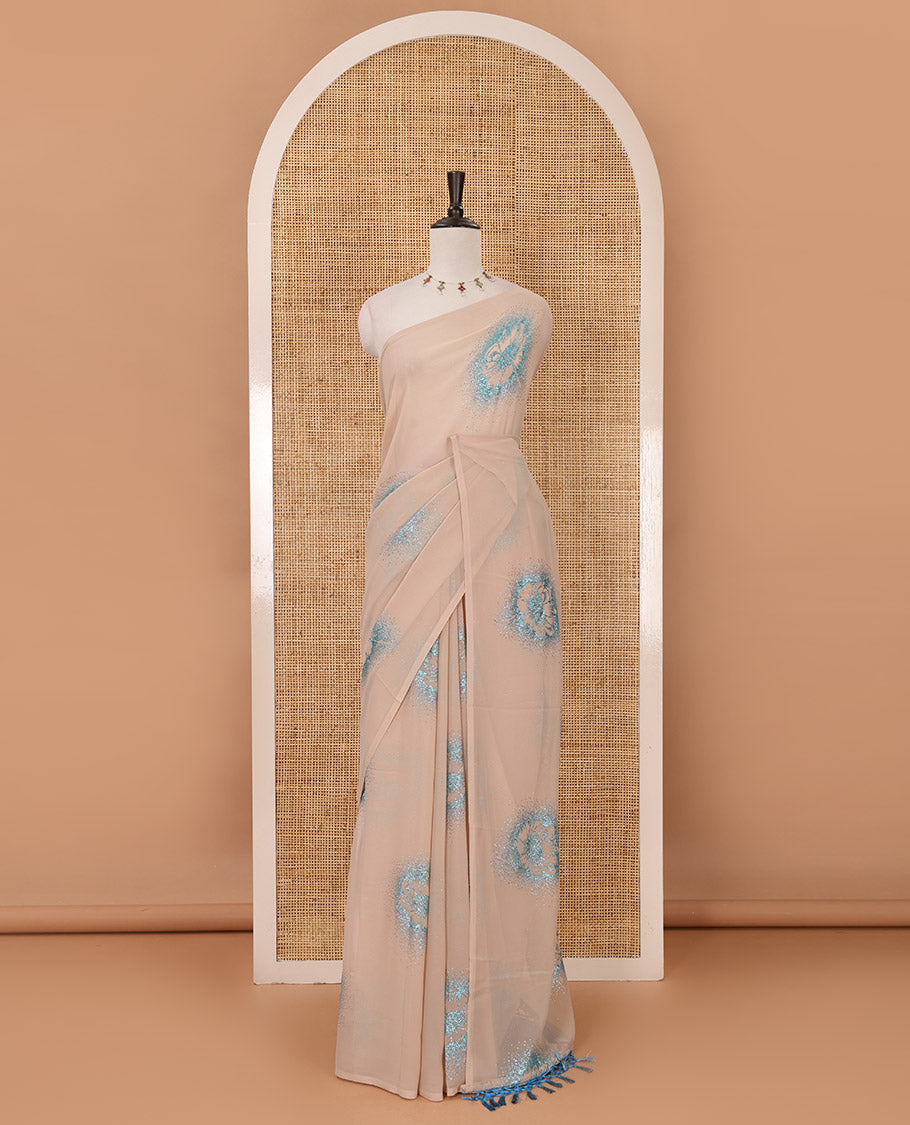 Borderless cream 60 gm georgette saree features floral vine designs, glitter embroidery work, contrast plain blouse