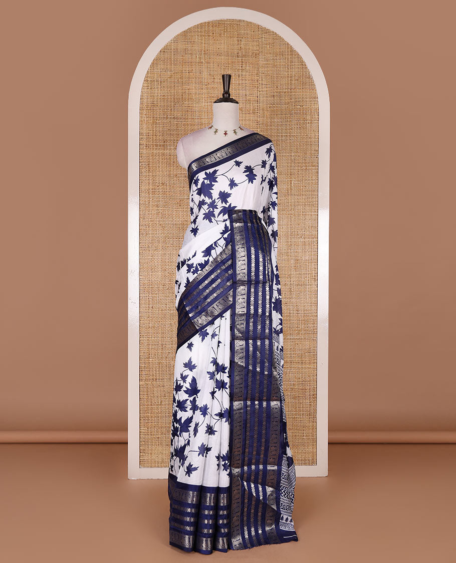 Navy blue leaf motifs printed dola silk saree, contrast traditional zari border of Rudraksham and peacock motifs, geometric printed pallu and contrast printed blouse
