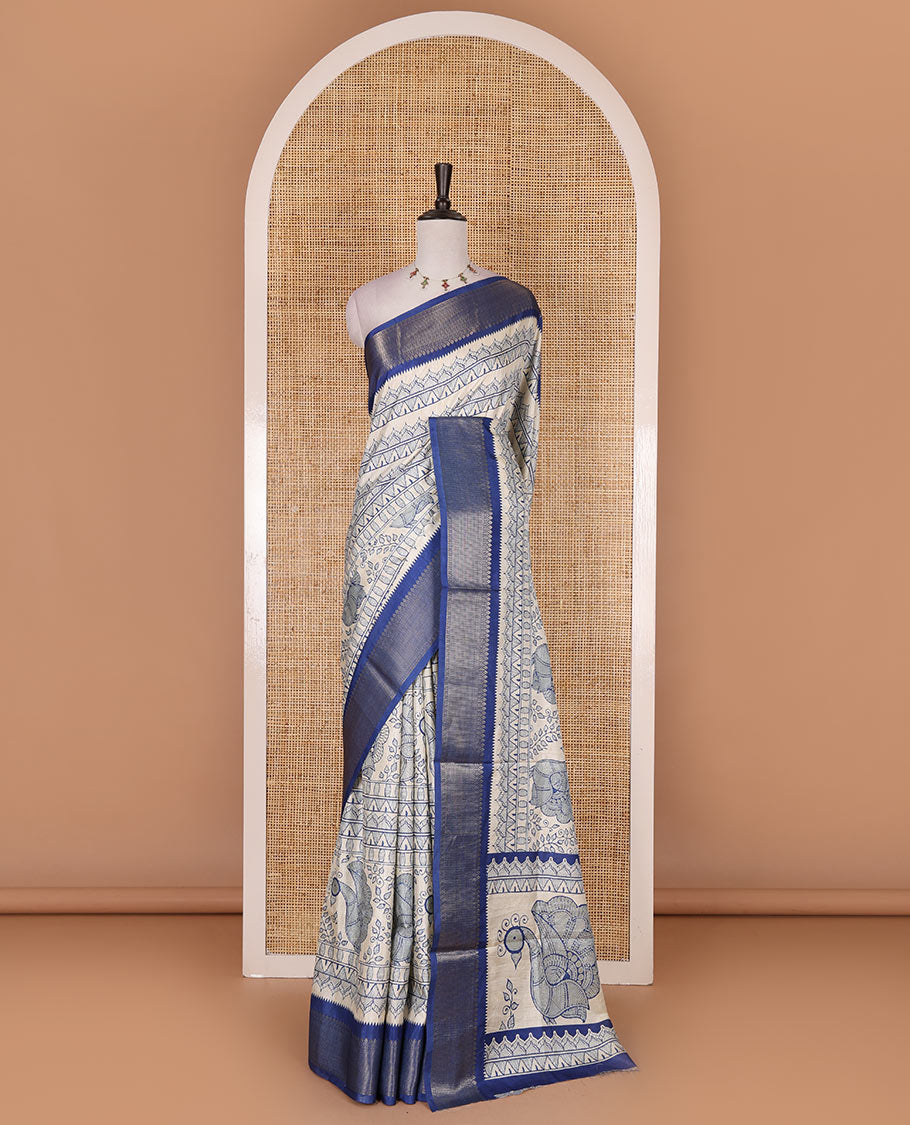 Cream-blue flora, fauna, and geometric madhubani printed soft tussar saree, contrast zari border, peacock print pallu, and printed blouse