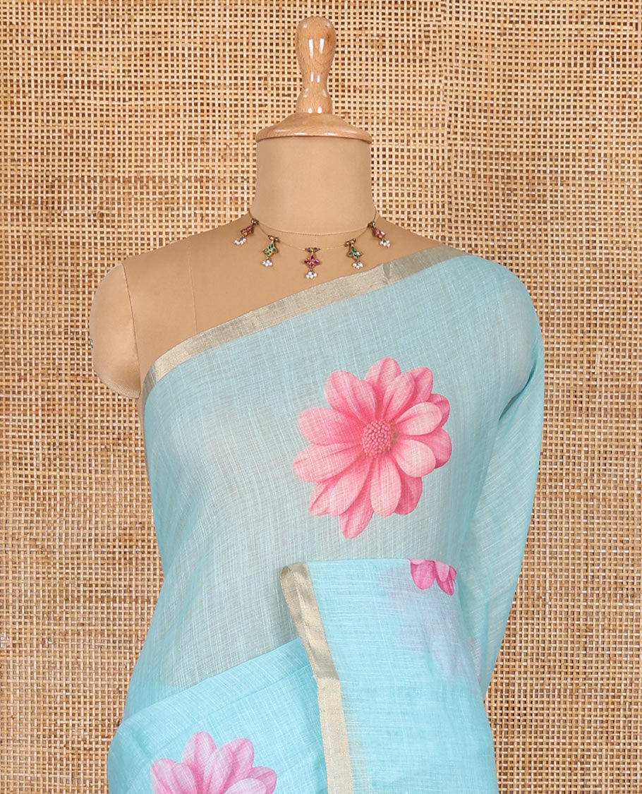 Sea blue daisy floral printed linen cotton saree, gold zari piping border, daisy floral printed pallu, and matching floral printed blouse