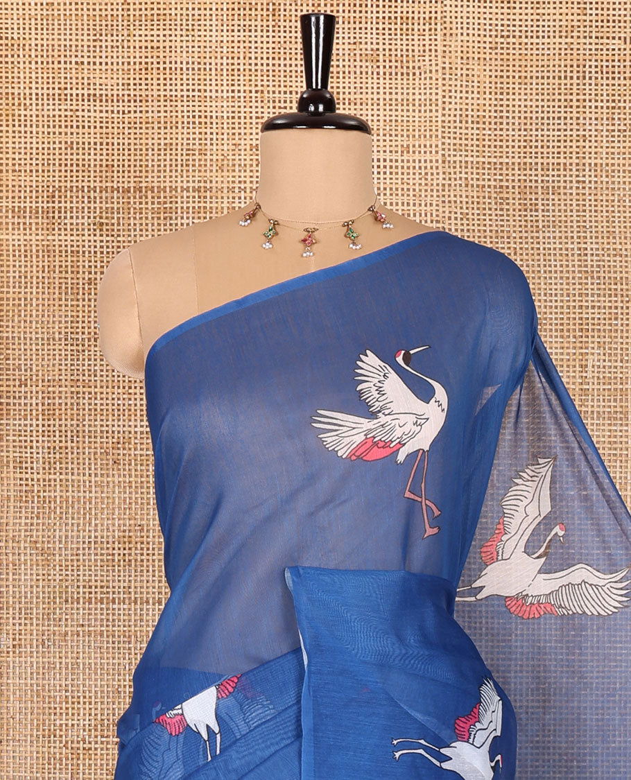 Borderless blue crane motifs printed linen cotton saree, crane motifs printed pallu, and a contrast crane printed blouse
