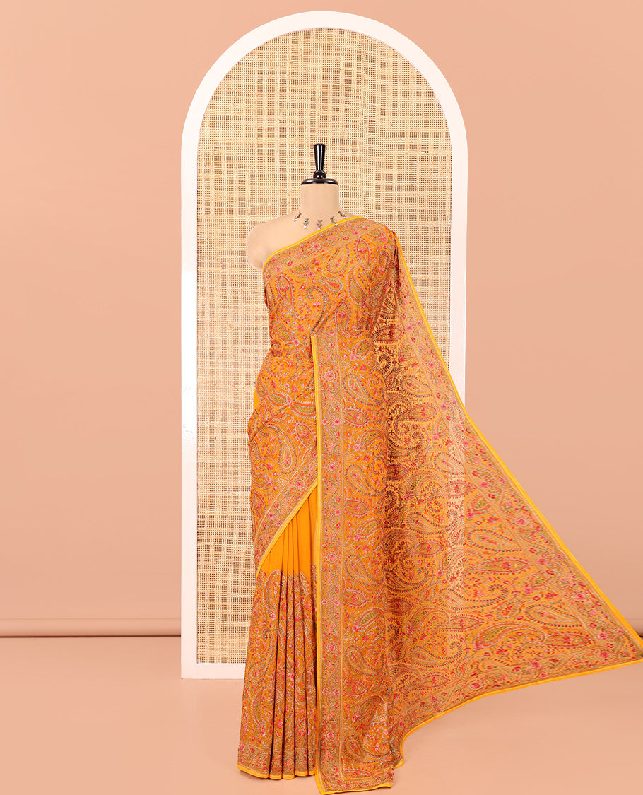 Mustard Georgette Saree, Ornamented with Intricate Paisleys, Kashmir Embroidered and Stone Work on Its Body, a Self-Embroidered Border, and Paired with an Embroidered Blouse